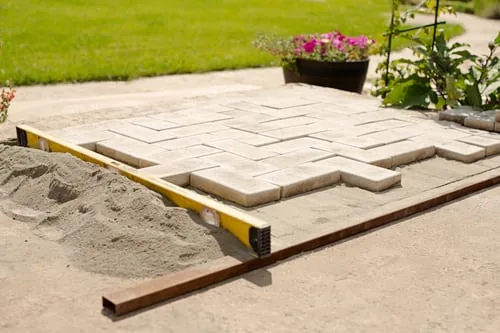 Compacted paver base being screeded before installation